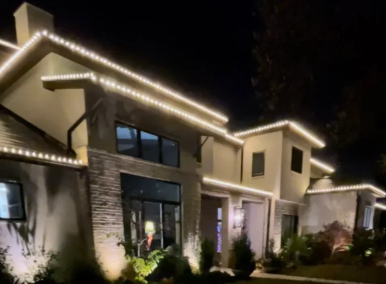 Modern home with warm white roofline Christmas lights Modern home with warm white roofline Christmas lights