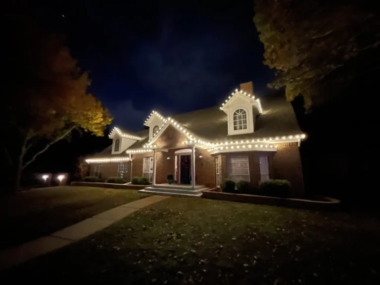Ranch-style home with warm white Christmas lights at night Ranch-style home with warm white Christmas lights at night