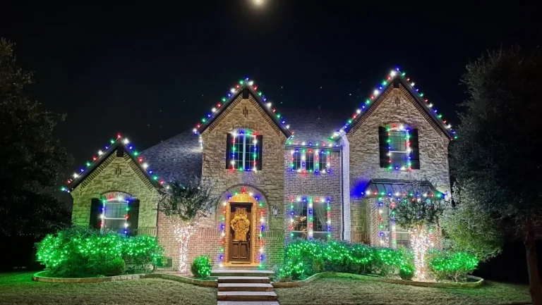 Blue and white Christmas lights on a stone home