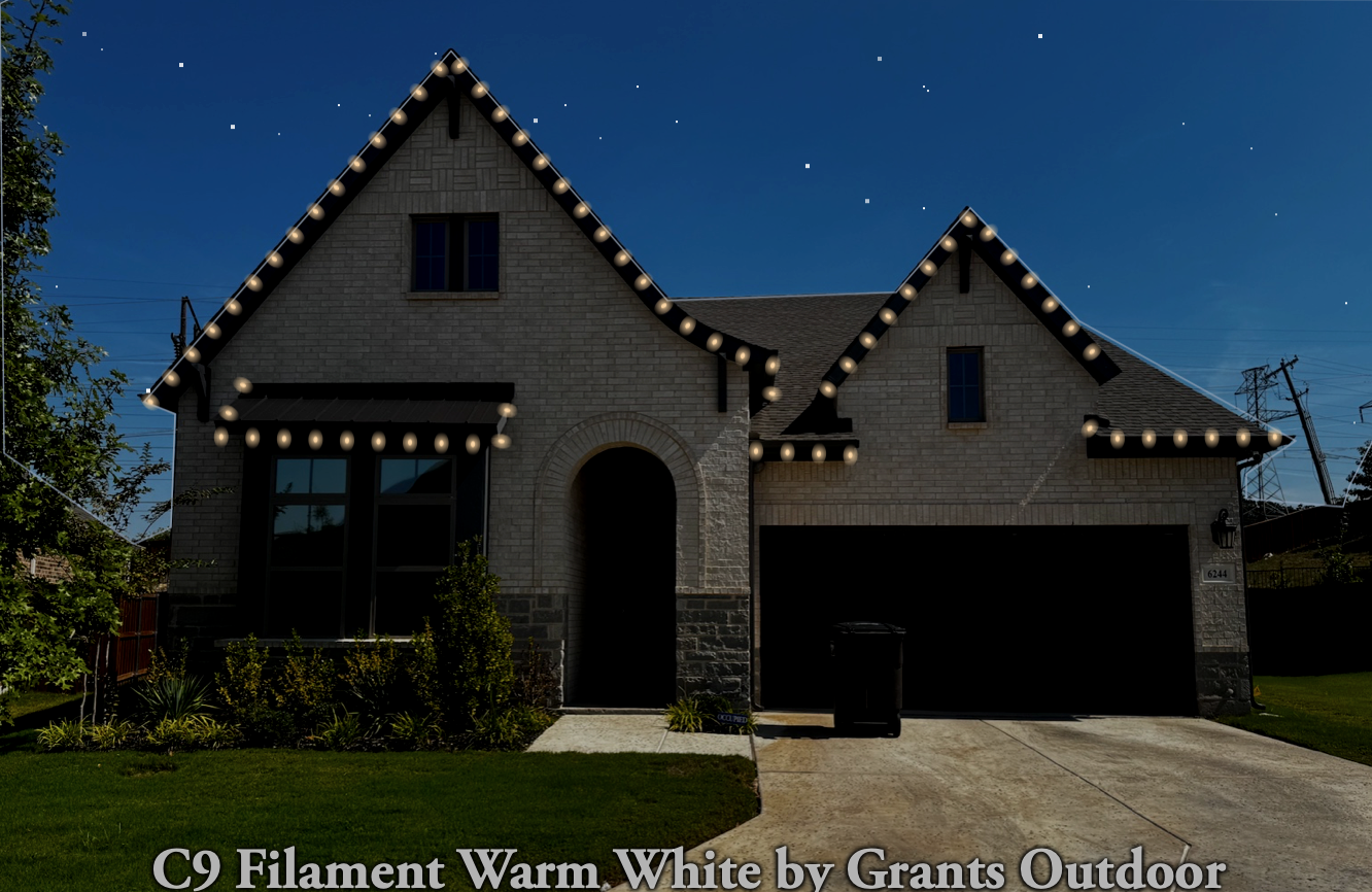Two-story home outlined in warm white C9 filament Christmas lights