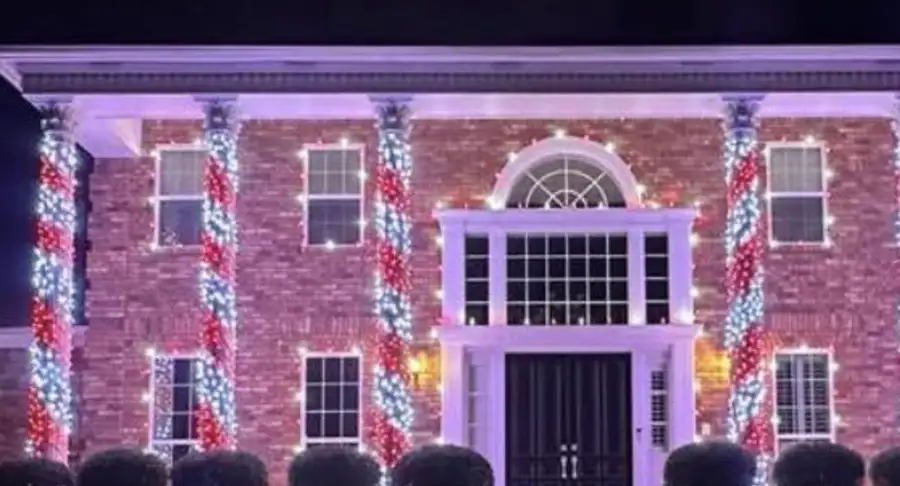 Christmas Light Installers GOAT Facebook group cover: brick home with red and white lights