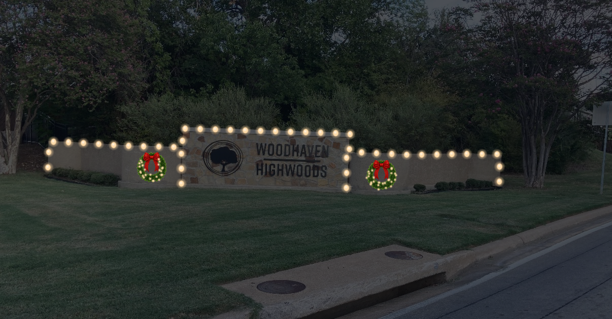 Neighborhood entrance sign outlined in Christmas lights