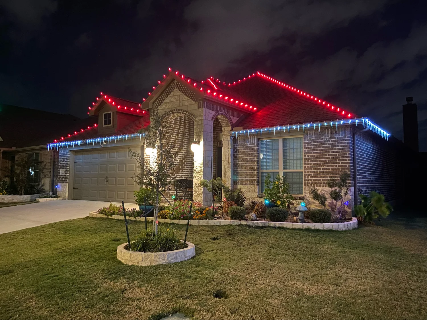 Home with red and white roofline Christmas lights